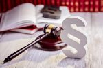 Symbols of law in court library with judge gavel